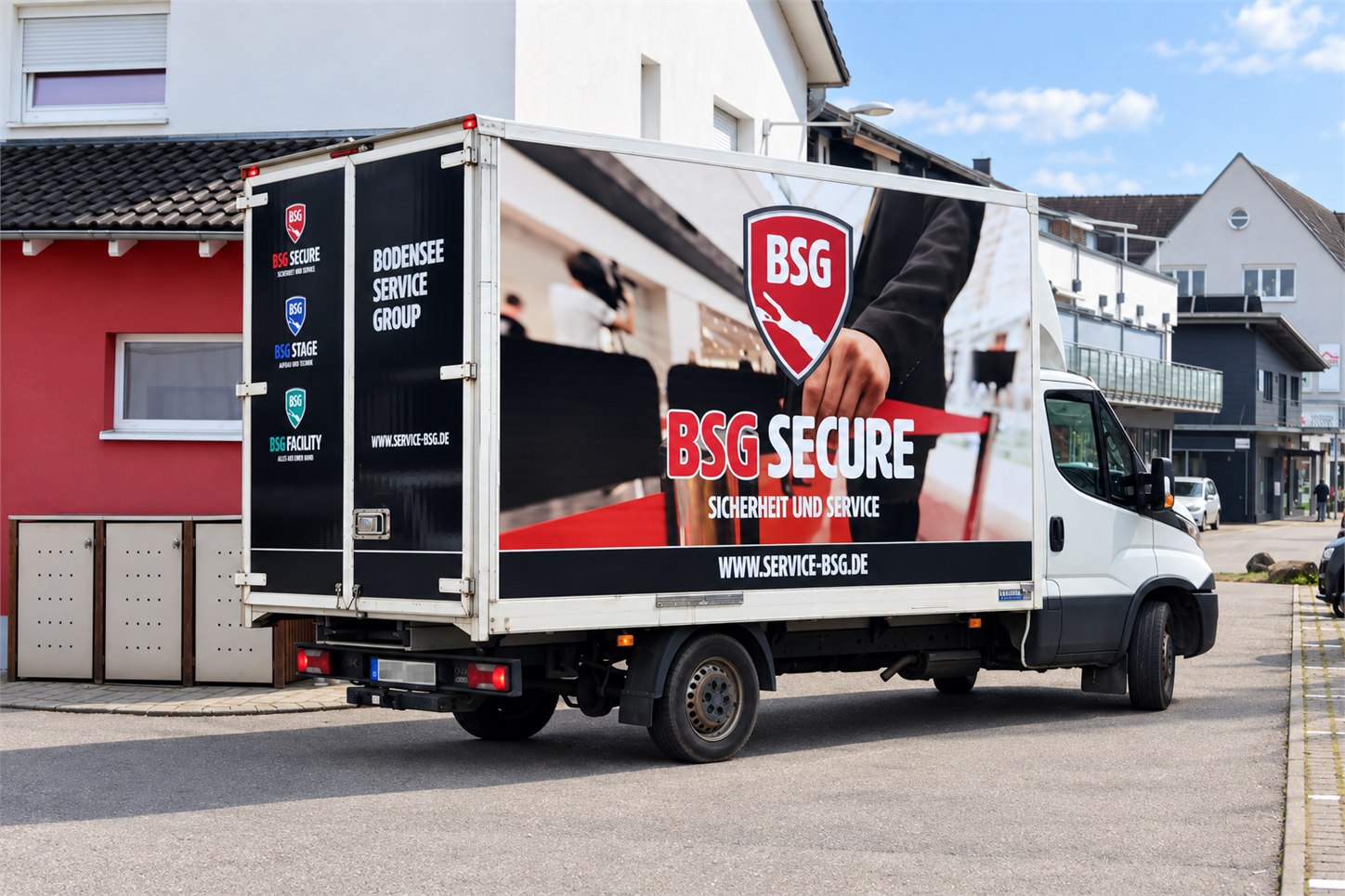 Koffertransporter mit großflächiger Fahrzeugbeschriftung für BSG Secure – Sicherheit und Service